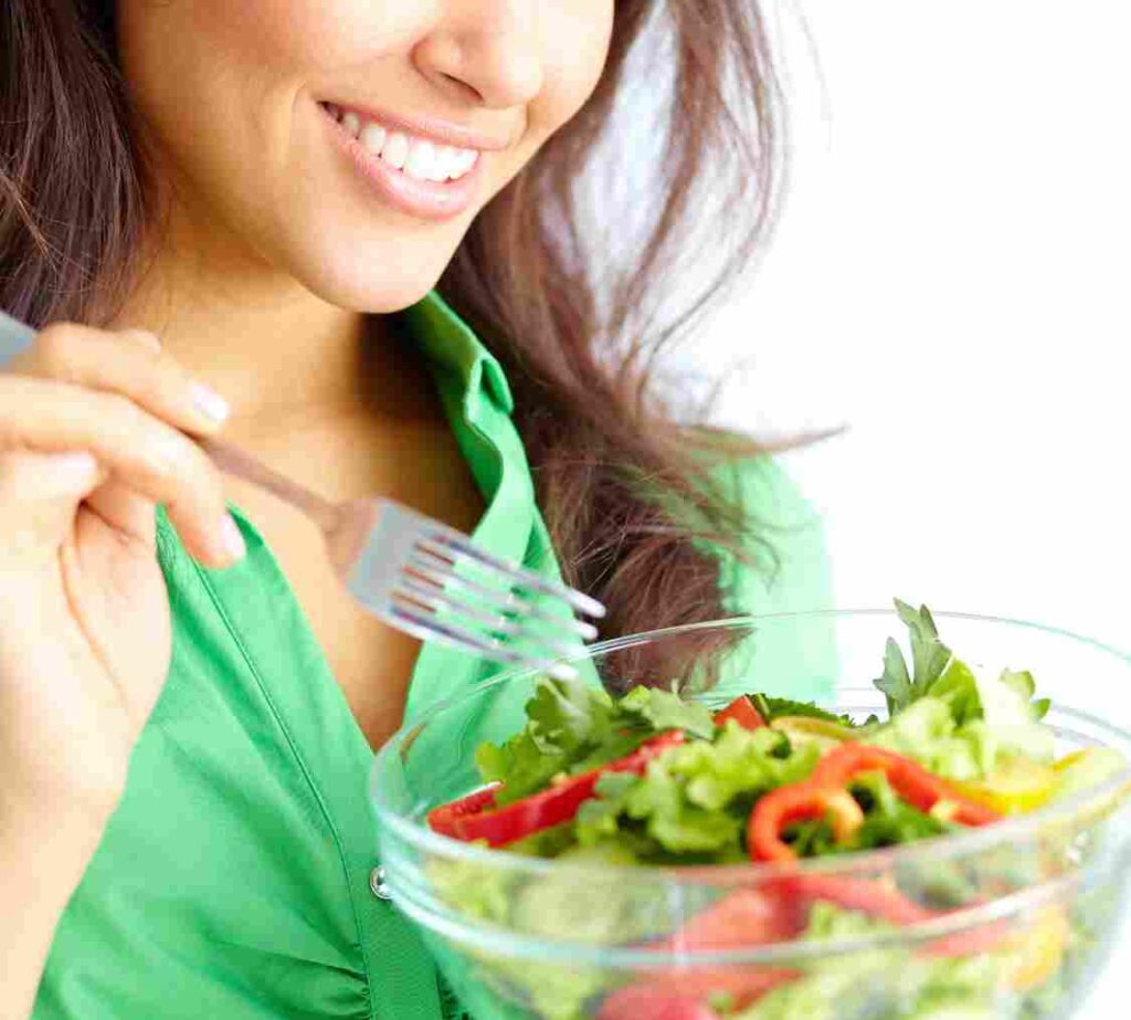 a woman eating a salad